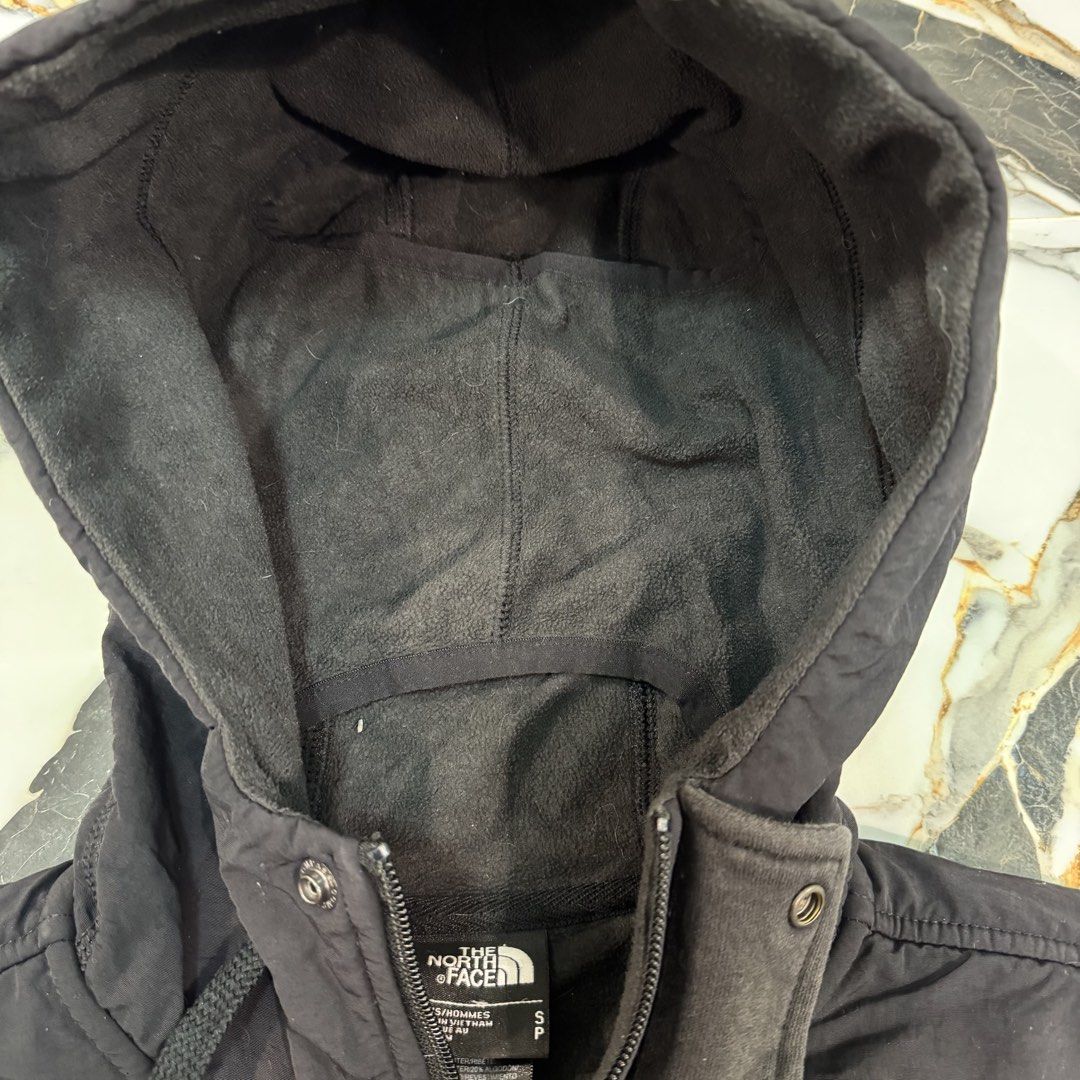 The North Face Black Hooded Jacket Size S (Category: Coats, Jackets and Outerwear) located in Manila. Submitted by fastflip.ph (Listing ID 1466726702, Image 3). Description: - Brand: The North Face - Color: Classic Black - Size: S (Made in Vietnam) - Closure: Full zip with additional snap buttons - Features: Drawstring hood, front pockets, ribbed cuffs and hem - Branding: White embroidered logo on the chest and back shoulder.