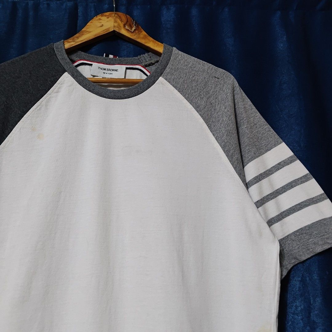 THOM BROWNE 4-BAR RAGLAN TEE (Category: Tshirts & Polo Shirts ) located in Makati City. Submitted by upcycled.closeth (Listing ID 1466609514, Image 3). Description: - Authentic Thom Browne product - White & Gray, short sleeve - Size: Large (men's) - Like new - Authentic - flaws: no flaws - Excellent condition - Need wash, fresh from bale - Features design of Thom Browne 4 bar design tee - Material: 100% cotton !!STILL NEGOTIABLE!!.