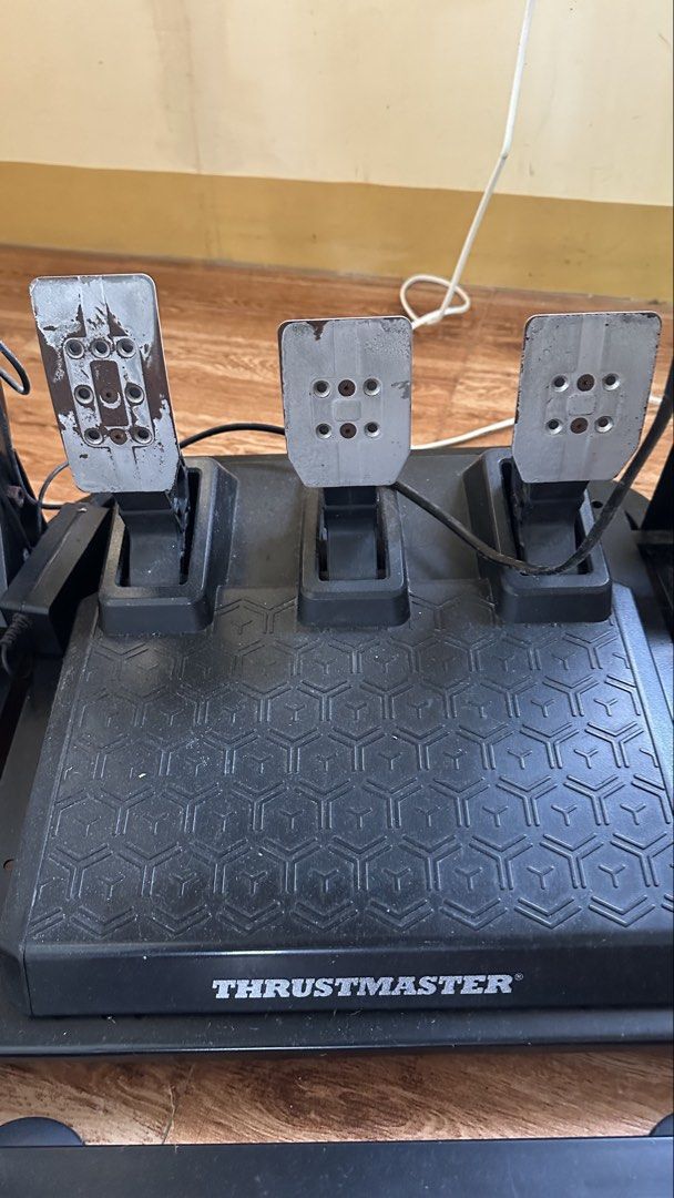 Thrustmaster T248-PS Racing Wheel and Pedals with Stand (Category: Controllers) located in Bauang. Submitted by jrnarch (Listing ID 1466639340, Image 3). Description: - Thrustmaster T248-PS racing wheel and 3-metal-pedal set - Includes a sturdy, adjustable metal stand for sim racing - Features immersive force feedback and a built-in display screen - Compatible with PlayStation and PC racing games - Tested and 100% fully functional - Minor cosmeti