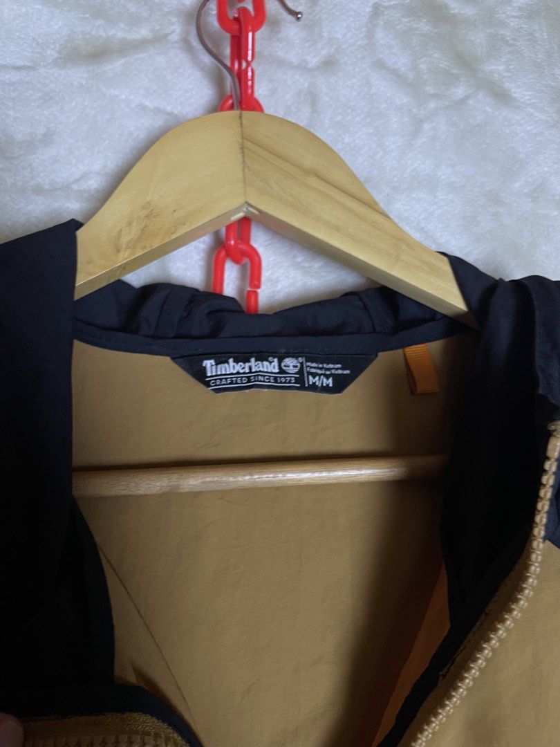 Timberland Windbreaker Jacket Brown Black Size M (Category: Coats, Jackets and Outerwear) located in Molave. Submitted by charlesthrifter (Listing ID 1466584554, Image 2). Description: - Brand: Timberland - Style: Windbreaker jacket - Color: Brown and black - Size: Medium (tag inside) - Features: Full zip front, adjustable hood with drawstrings, dual side pockets - Details: Subtle Timberland wordmark on black sleeve and patch logo on chest - Mate