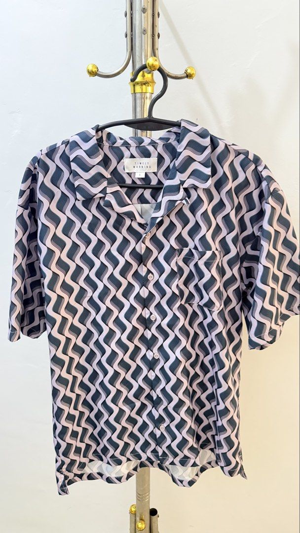 Timely Warning Wave Print Short Sleeve Button Up Shirt (Category: Longsleeves) located in Manila. Submitted by laxamanapa81165 (Listing ID 1466570117, Image 1). Description: - Brand: Timely Warning - Size: L - Design: Wavy geometric pattern in light pink and dark grey - Details: Camp collar, front chest pocket, regular short sleeve fit - Condition: Great statement piece for casual wear.