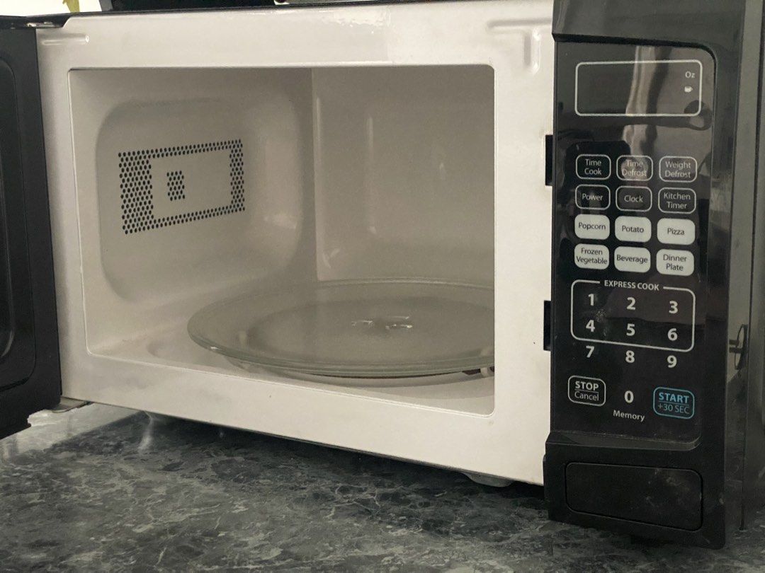 Toastmaster Microwave Oven (110V) (Category: Ovens & Toasters) located in San Juan City. Submitted by jgoods11 (Listing ID 1466566264, Image 2). Description: - Brand: Toastmaster - Color: Sleek black countertop design - Controls: Digital control pad with presets for popcorn, potato, pizza, and more - Features: Express cook number pads and convenient +30 seconds button - Interior: Clean white walls with rotating glass turntable.