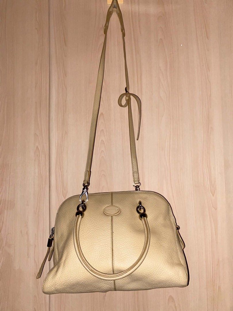 Tod's Beige Leather Shoulder Bag Satchel (Category: Shoulder Bags) located in Placer. Submitted by talaalond61563 (Listing ID 1466633343, Image 1). Description: - Brand: Tod's - Material: Premium pebbled leather in a versatile soft beige shade - Straps: Double top handles and an adjustable, detachable crossbody strap - Hardware: Sleek silver-tone hardware with top zip closure - Lampo under zipper - Design: Center vertical seam detail on front and