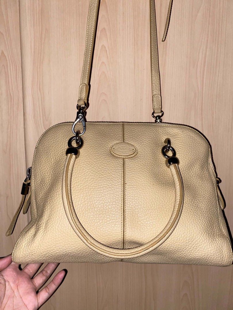 Tod's Beige Leather Shoulder Bag Satchel (Category: Shoulder Bags) located in Placer. Submitted by talaalond61563 (Listing ID 1466633343, Image 2). Description: - Brand: Tod's - Material: Premium pebbled leather in a versatile soft beige shade - Straps: Double top handles and an adjustable, detachable crossbody strap - Hardware: Sleek silver-tone hardware with top zip closure - Lampo under zipper - Design: Center vertical seam detail on front and