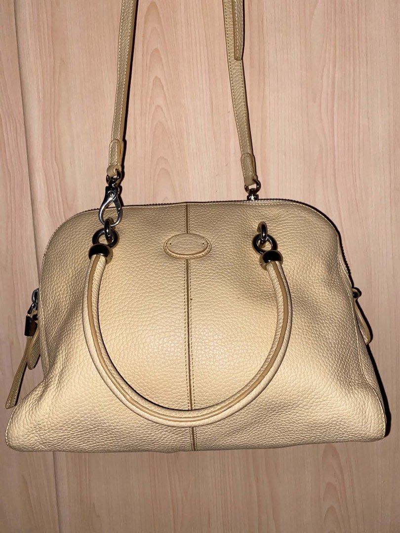 Tod's Beige Leather Shoulder Bag Satchel (Category: Shoulder Bags) located in Placer. Submitted by talaalond61563 (Listing ID 1466633343, Image 3). Description: - Brand: Tod's - Material: Premium pebbled leather in a versatile soft beige shade - Straps: Double top handles and an adjustable, detachable crossbody strap - Hardware: Sleek silver-tone hardware with top zip closure - Lampo under zipper - Design: Center vertical seam detail on front and