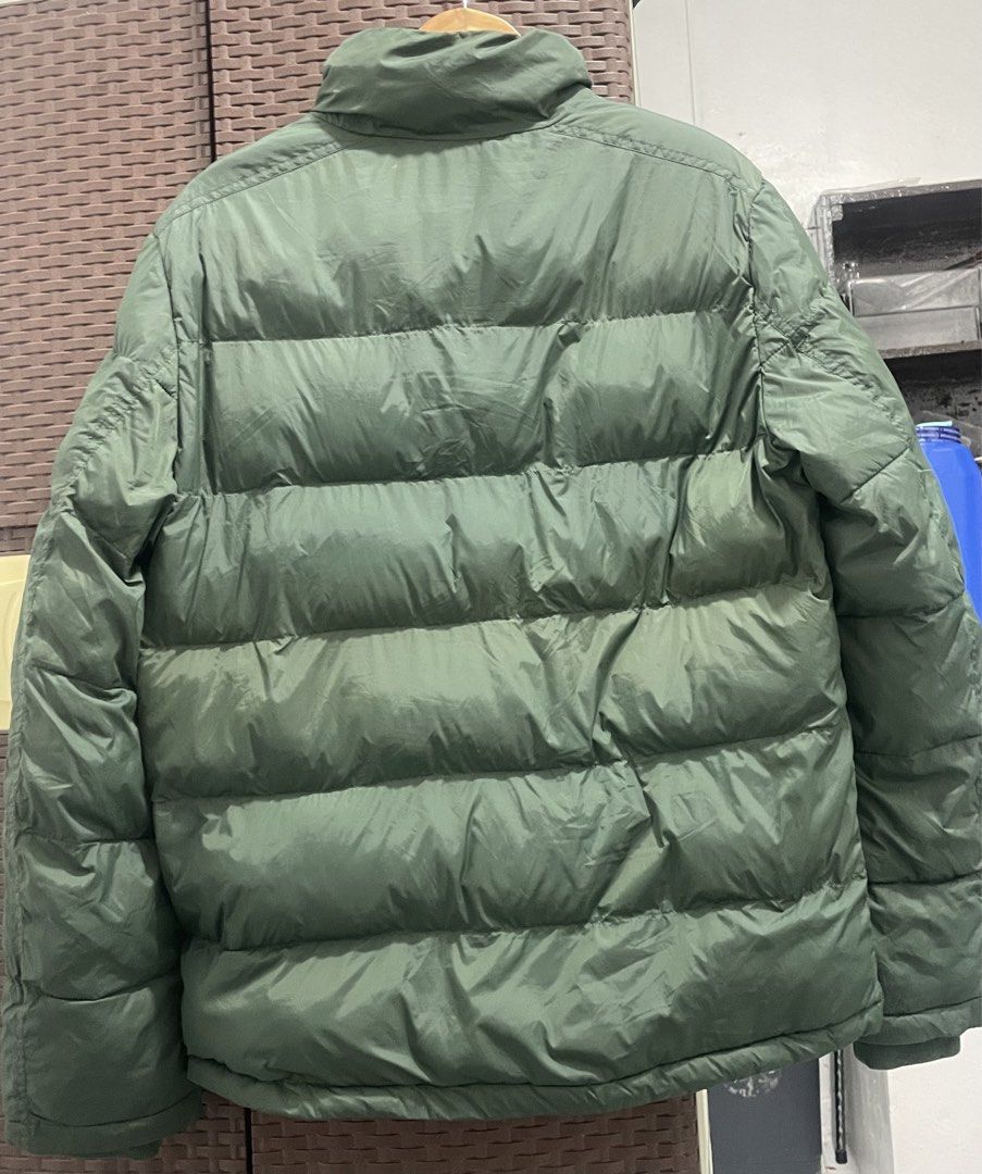 Tommy Hilfiger Green Puffer Jacket (Category: Coats, Jackets and Outerwear) located in Manila. Submitted by oenthrift.2026 (Listing ID 1466709141, Image 2). Description: - Brand: Tommy Hilfiger - Color: Olive green with bright orange inner lining - Design: High collar with ribbed inner lining, full zip and snap button closure - Details: Iconic embroidered flag logo on the left chest - Pockets: Two functional front slash pockets - Warmth: Heavy qu