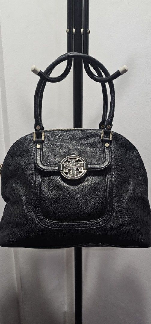 Tory Burch Black Leather Tote Bag (Category: Tote Bags) located in Quezon City. Submitted by winwinr (Listing ID 1466772394, Image 1). Description: - Brand: Tory Burch - Material: Premium black pebble leather - Hardware: Elegant gold-tone hardware with signature T logo medallion - Closure & Handles: Secure zipper closure with dual top handles - Interior: Spacious compartment for daily essentials - Condition: Good, with minor creasing from storage