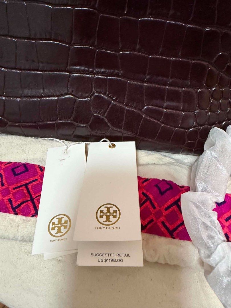 Tory Burch Crocodile Embossed Leather Handbag (Category: Luxury Bags & Wallets) located in Quezon City. Submitted by rhonadc (Listing ID 1466676291, Image 2). Description: - Brand: Tory Burch - Material: Dark brown crocodile embossed leather - Hardware: Elegant gold accent clasp - Includes: Matching print scarf and adjustable shoulder strap (still in protective foam) - Condition: Brand new with original US $1198.00 retail tags attached.