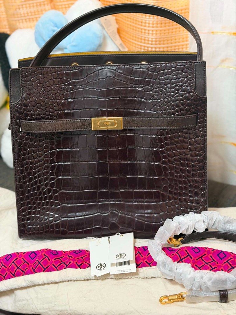 Tory Burch Crocodile Embossed Leather Handbag (Category: Luxury Bags & Wallets) located in Quezon City. Submitted by rhonadc (Listing ID 1466676291, Image 1). Description: - Brand: Tory Burch - Material: Dark brown crocodile embossed leather - Hardware: Elegant gold accent clasp - Includes: Matching print scarf and adjustable shoulder strap (still in protective foam) - Condition: Brand new with original US $1198.00 retail tags attached.