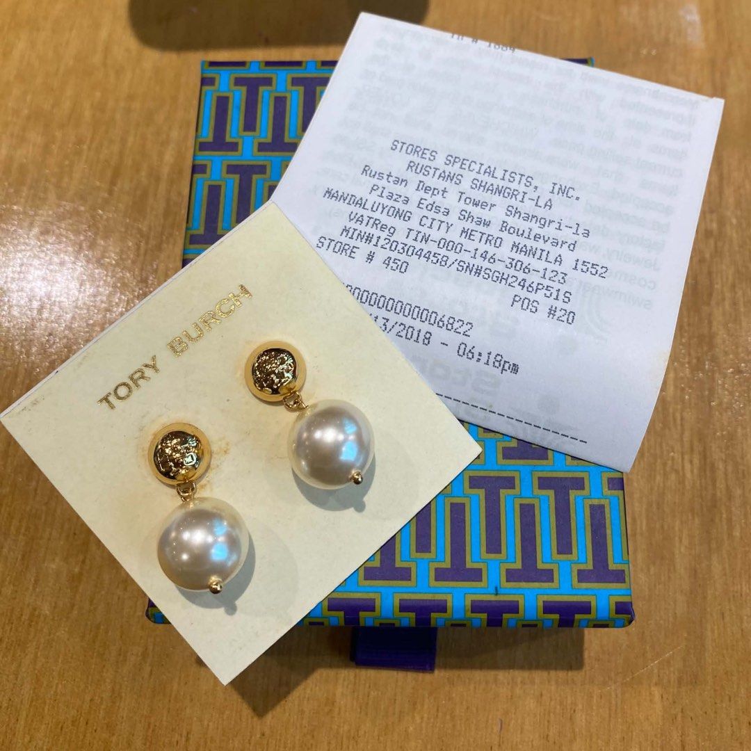 Tory Burch Pearl Drop Earrings (Category: Luxury Accessories) located in Cavite. Submitted by florabells (Listing ID 1466655967, Image 1). Description: - Brand: Tory Burch - Design: Gold-tone with textured top button and hanging faux pearls - Inclusions: Original blue and purple printed box, paper tag, and Rustans Shangri-La receipt - Condition: Excellent / Like new - Perfect for gifts or everyday elegance - Meetups and shipping options available