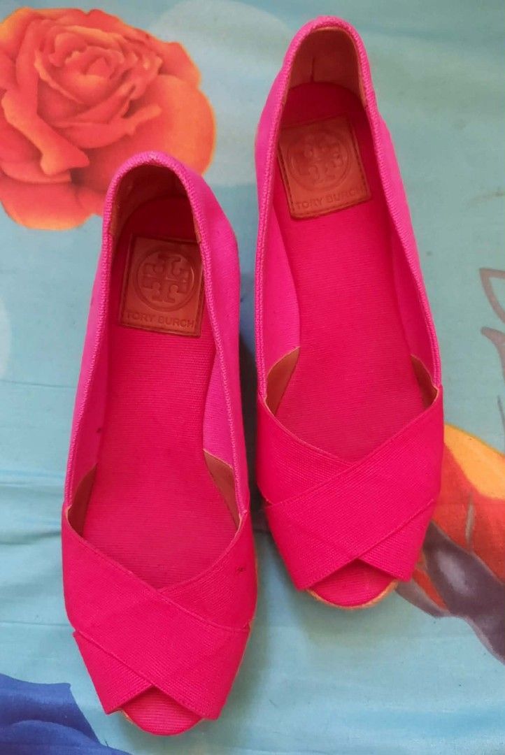 Tory Burch Pink Canvas Espadrille Wedges (Category: Wedges) located in Nabunturan. Submitted by kairosas85 (Listing ID 1466587274, Image 1). Description: - Brand: Tory Burch - Style: Open-toe espadrille wedges with crossover canvas straps - Color: Bright pink - Features: Braided jute heel wedge, textured rubber sole, embossed leather inner sole patch, and subtle tonal logo stamp on outer heel - Condition/Vibe: Vibrant summer shoes, easy to style 