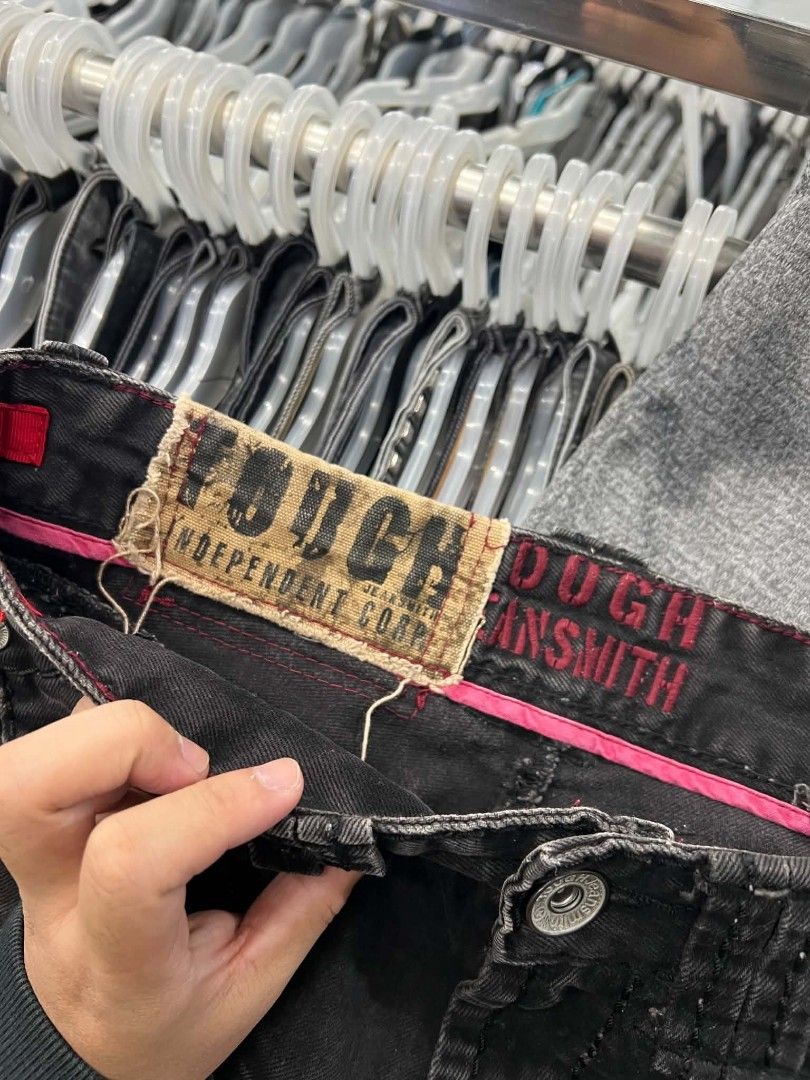 Tough Jeanssmith Black Distressed Denim Jeans (Category: Jeans) located in Urdaneta. Submitted by jayceegarage (Listing ID 1466721079, Image 3). Description: - Brand: Tough Jeanssmith - Color/Finish: Black with a heavily washed, distressed look - Fit: Straight cut, highly durable fabric - Unique Details: Metal grommet strap hanging from the back pocket and classic zig-zag stitching - Branding: Vintage 1957 tag on the waistband - Condition: Excell