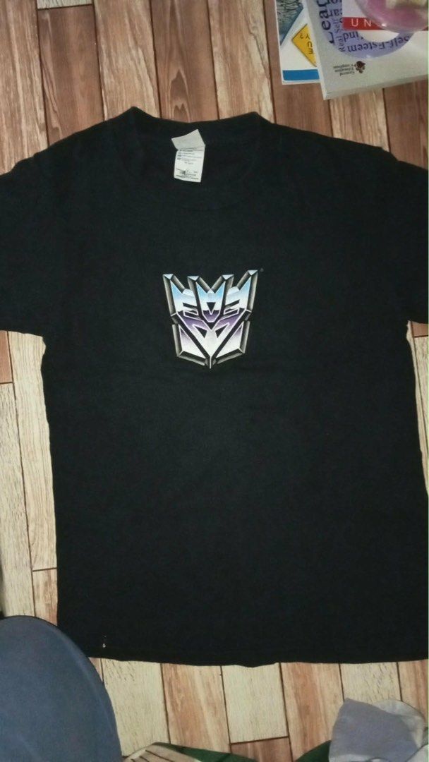 Transformers Decepticon Logo Black T-Shirt (Category: Tshirts & Polo Shirts ) located in Manila. Submitted by fleis.it (Listing ID 1466687451, Image 1). Description: - Color: Solid black - Design: Silver and purple Decepticon emblem on the chest - Fit: Regular adult sizing, short sleeves, standard crew neck - Material: 100% machine washable cotton - Condition: Brand new / Excellent quality - Mode of Payment: GCash, BPI, or COD available - Shippin