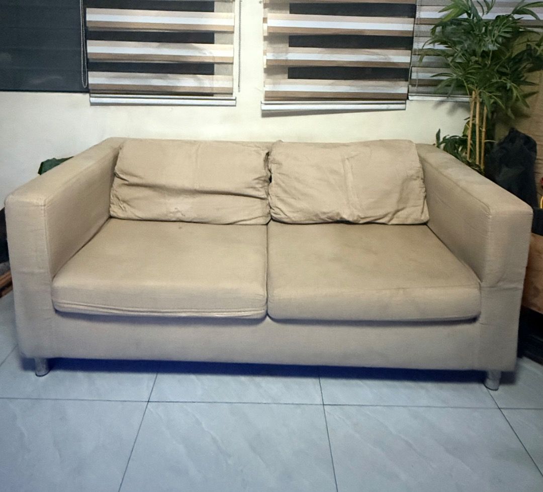 Two-Seater Sofa Beige (Category: Sofas) located in Caloocan City. Submitted by xinne87 (Listing ID 1466575769, Image 1). Description: - 2-seater fabric sofa with thick back cushions and wide armrests for ultimate comfort - Includes TWO complete slipcover sets: versatile solid beige and stylish bold red patterned - Sturdy build supported by short, modern metal legs - Ideal size for living rooms, guest rooms, or condo/apartment spaces - Easy to cle