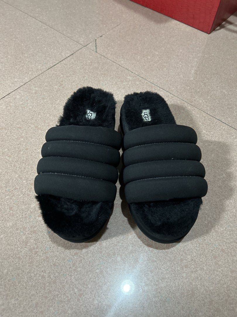 UGG Fluffita Black Slippers (Category: Slippers and slides) located in Alitagtag. Submitted by patrickvillanueva (Listing ID 1466597256, Image 1). Description: - Brand: UGG - Style: Fuzzy slip-on sandals with puffy strap design - Comfort: Super soft fleece lining and footbed for ultimate coziness - Sole: Treadlite by UGG with deep grooved treads for extra grip - Condition: Great shape, only shows slight dust on the sole bottoms from indoor try-on