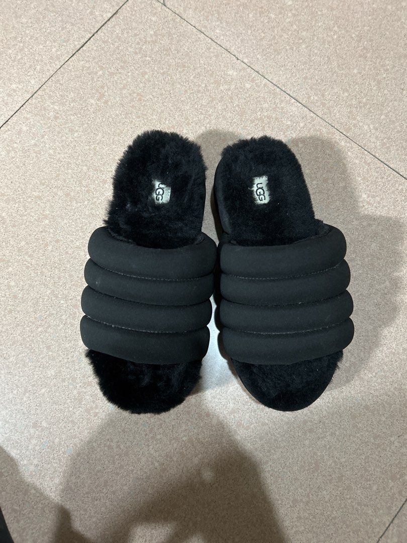 UGG Fluffita Black Slippers (Category: Slippers and slides) located in Alitagtag. Submitted by patrickvillanueva (Listing ID 1466597256, Image 2). Description: - Brand: UGG - Style: Fuzzy slip-on sandals with puffy strap design - Comfort: Super soft fleece lining and footbed for ultimate coziness - Sole: Treadlite by UGG with deep grooved treads for extra grip - Condition: Great shape, only shows slight dust on the sole bottoms from indoor try-on