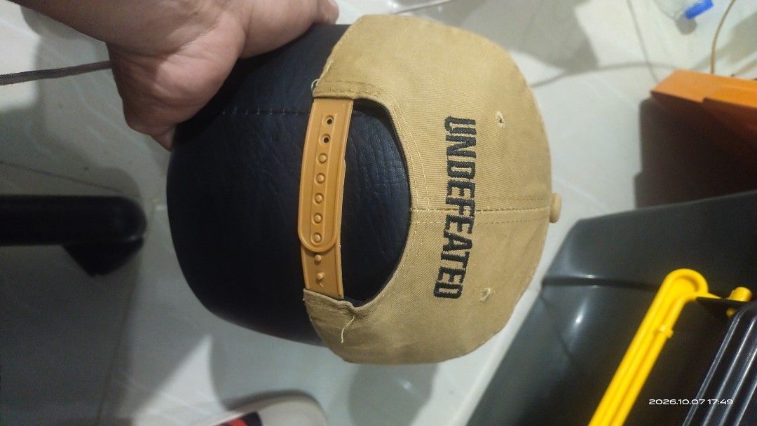Undefeated Snapback Hat Tan Black (Category: Caps & Hats) located in Manila. Submitted by rhobin.m08 (Listing ID 1466701922, Image 2). Description: - Brand: Undefeated - Color: Tan and black - Design: Embroidered five-strike logo on front and brand lettering on back - Brim: Flat brim with original Yupoong sticker attached - Closure: Adjustable plastic snapback strap - Interior: Branded taped seams for authenticity - Condition: Brand new / Excelle