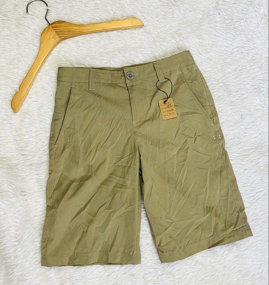 Under Armour Khaki Shorts Size 25-26 (Category: Shorts) located in Manila. Submitted by bengirlclothing (Listing ID 1466612942, Image 2). Description: - Brand: Under Armour - Color: Khaki - Style: Loose fit shorts - Size: 25-26 inches - Details: Neon yellow/green UA logo inner waistband, small UA logo on lower left leg - Features: Button closure, belt loops, front pockets - Origin: Made in Indonesia .