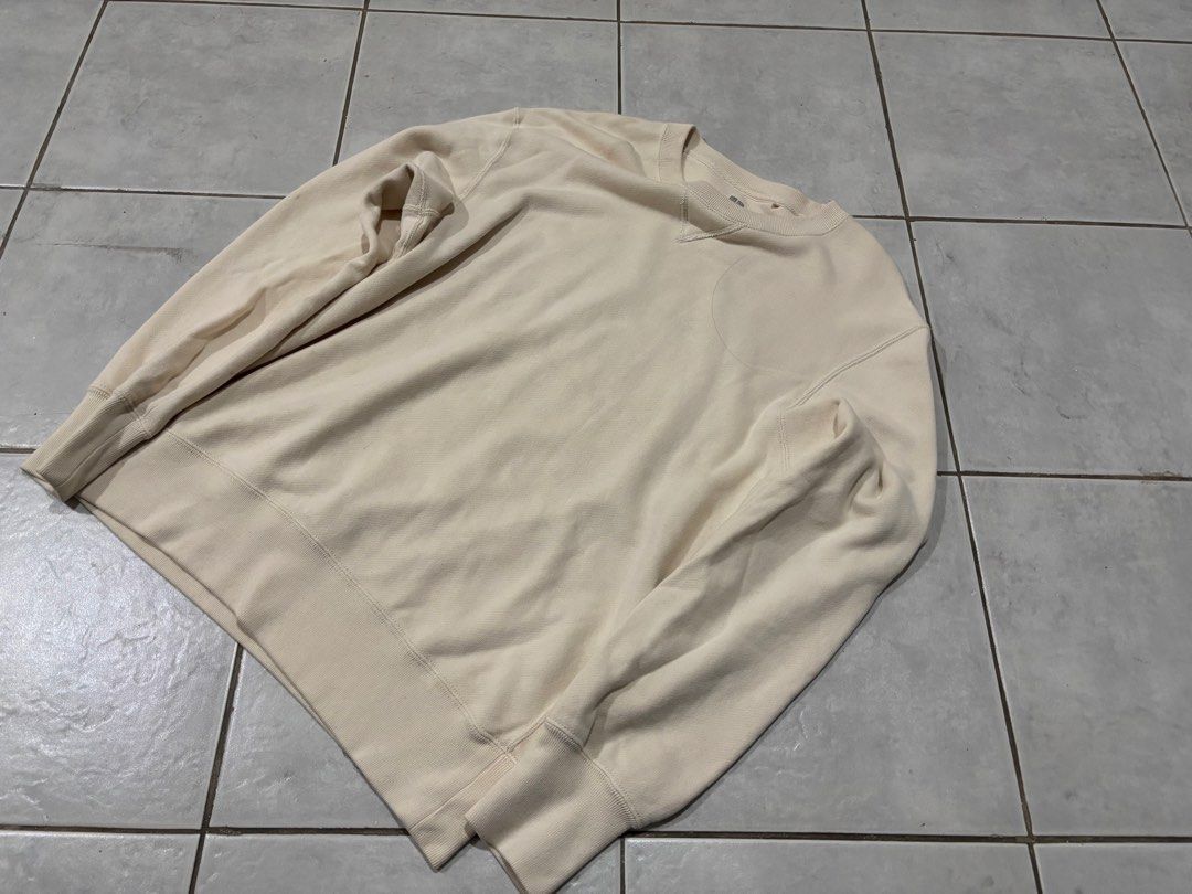 Uniqlo Cream Sweatshirt Size L (Category: Coats, Jackets and Outerwear) located in Santa Rosa. Submitted by rahbii (Listing ID 1466565246, Image 1). Description: - Brand: Uniqlo - Item: Crewneck Sweatshirt - Color: Cream / Off-white - Size: L (Tag on inner collar) - Material: Thick cotton fleece (Made in Vietnam) - Details: Classic V-stitch at the neckline, ribbed cuffs and hem - Condition: Barely worn, stored in a smoke-free wardrobe.