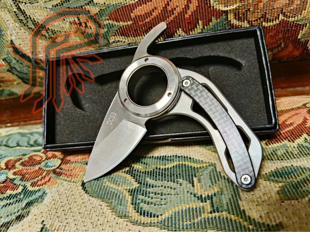 Unique folding ring pocket knife with DC53 blade (Category: Knives & Chopping Boards) located in Quezon City. Submitted by liana.finds (Listing ID 1465797876, Image 1). Description: - Brand New from pasyal heavy industries - Unique tactical folding knife with a curved blade and central finger ring - Premium DC53 steel blade known for great edge retention - Stylish carbon fiber handle inlay with metal accents - Smooth deployment and reliable mecha