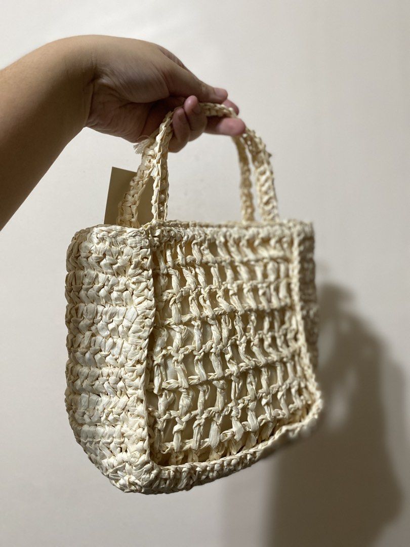 Universal Thread Amore Straw Tote Bag Off-White (Category: Tote Bags) located in Batangas. Submitted by lux_kimmy (Listing ID 1466671692, Image 2). Description: - Brand: Universal Thread US - Style: Woven straw tote bag in off-white - Details: Black embroidered 'AMORE' lettering on the front - Features: Fully lined interior, magnetic snap closure, inner brand patch, and double top handles - Condition: Brand new with original retail tags attached,