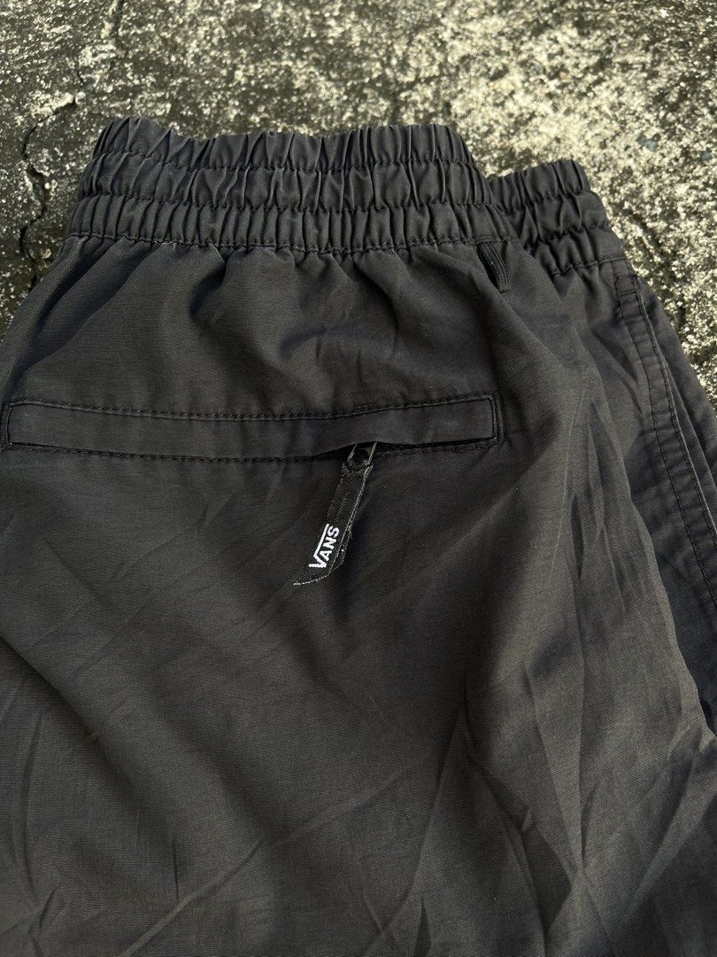 Vans Black Nylon Shorts Size Small (Category: Shorts) located in Tarlac. Submitted by supremo.0 (Listing ID 1466632824, Image 3). Description: - Brand: Vans - Color: Classic Black color rate 8.5/10 - Size: Small - Material: Durable nylon with breathable mesh lining - Fit: Elastic waistband with adjustable drawstring closure - Storage: Convenient side pockets + 1 secure zippered back pocket - Details: Iconic Vans logo patch near the hem - Origin: 
