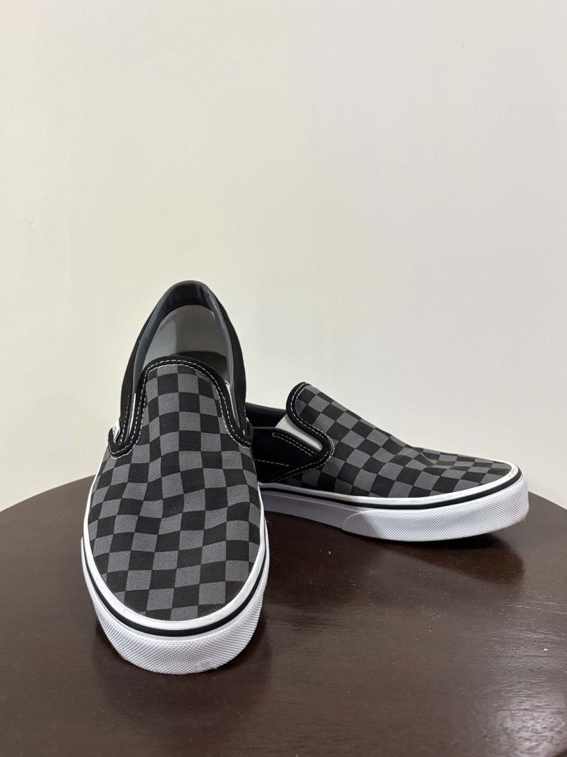 Vans Checkerboard Slip-On Black Grey (Category: Sneakers) located in Leyte. Submitted by katserafica (Listing ID 1466698226, Image 1). Description: - Brand: Vans - Style: Classic Slip-On (Black/Grey Checkerboard) - Size: US Men 7.5 / US Women 9.0 - Material: Durable canvas upper with elastic side accents - Sole: Signature waffle rubber outsole for reliable grip - Condition: Clean, with barely any wear on the soles.