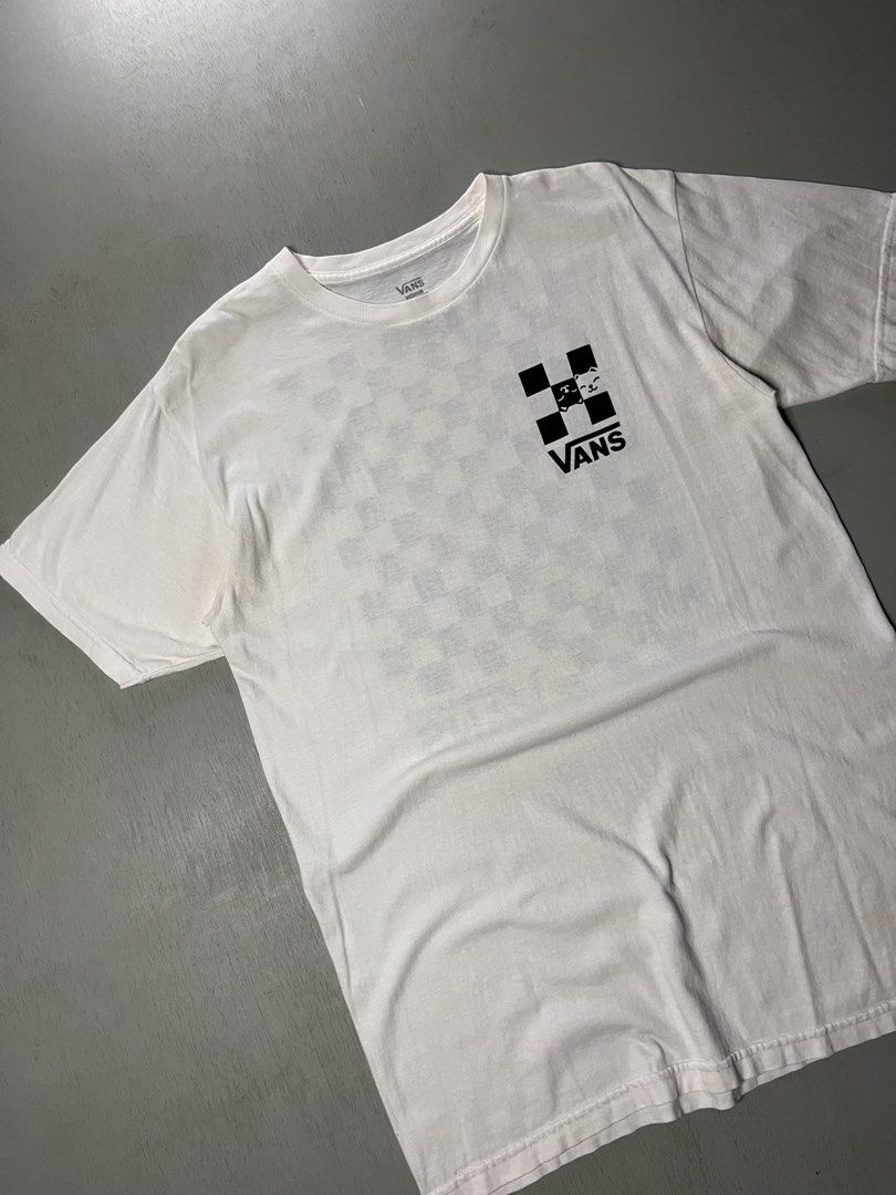 Vans White Shirt (Category: Activewear) located in Catbalogan. Submitted by yellfindss (Listing ID 1466745459, Image 3). Description: - Brand: Vans -19/28 - Color: White with black checkered cat graphic design - Size: Medium - Material: 100% cotton - Features: Small chest graphic and large statement graphic on the back - Condition: Well-maintained and ready to wear.