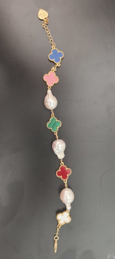 VCA Clover and Baroque Pearl Bracelet (Category: Bracelets) located in Batangas. Submitted by decluttering_bliss (Listing ID 1466773680, Image 1). Description: - Gold-tone chain bracelet with vibrant multi-colored stones clovers (mother of pearl, carnelian, malachite, etc) - Beautiful alternating baroque pearls between each clover charm - Adjustable chain link closure for a customized fit - Finished with a signature Miss Careque small heart-shape