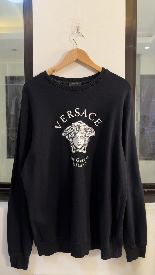 Versace Medusa Logo Sweatshirt Black (Category: Coats, Jackets and Outerwear) located in Paranaque City. Submitted by preluxeshop_ph (Listing ID 1466765738, Image 2). Description: Versace Medusa Logo Sweatshirt Black -Iconic Medusa logo and ‘via Gesù 12 MILANO’ print -Condition: 9.8/10 -Dimes: Length: 27” Width: 22”.