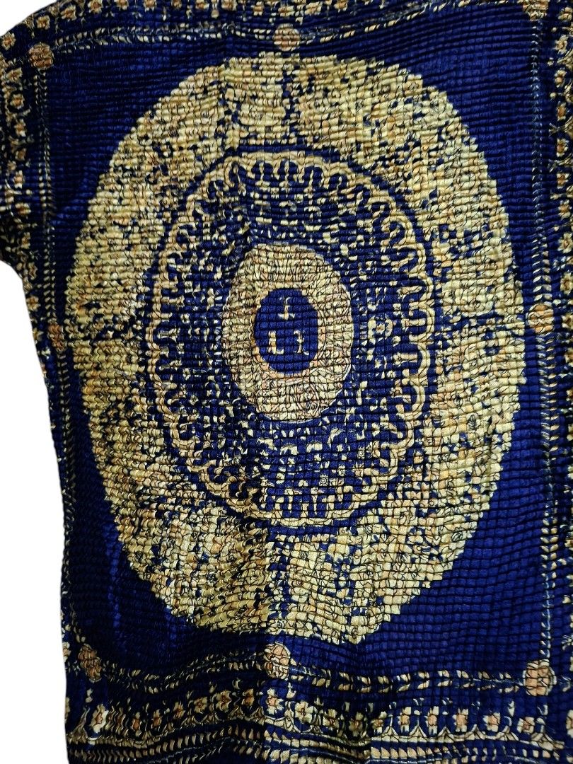 Versace Pleated Silk Top (Category: Luxury Apparel) located in Leyte. Submitted by jpsrvd19 (Listing ID 1466691414, Image 3). Description: - Versace Pleated Silk Top - Color/Print: Deep blue with a striking gold baroque medallion and floral print - Material: Lightweight, crinkled, and stretchy texture for a comfortable fit - Design: Mock neck collar and short cap sleeves - Details: Bold circular chest pattern and stitched Versace label inside - F