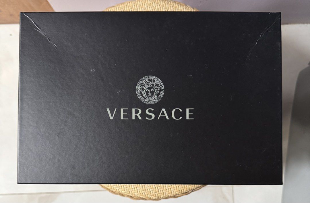 Versace Sandals Box (Category: Luxury Accessories) located in Paranaque City. Submitted by joyjoygeneral.merchandise (Listing ID 1466598388, Image 1). Description: Versace Original Box – For Sandals Original black Versace packaging with the classic Medusa logo and Versace branding. The box is pre-loved and shows some light scratches/handling marks, but the branding and overall structure are intact. Suitable for storing or packaging Versace sandal