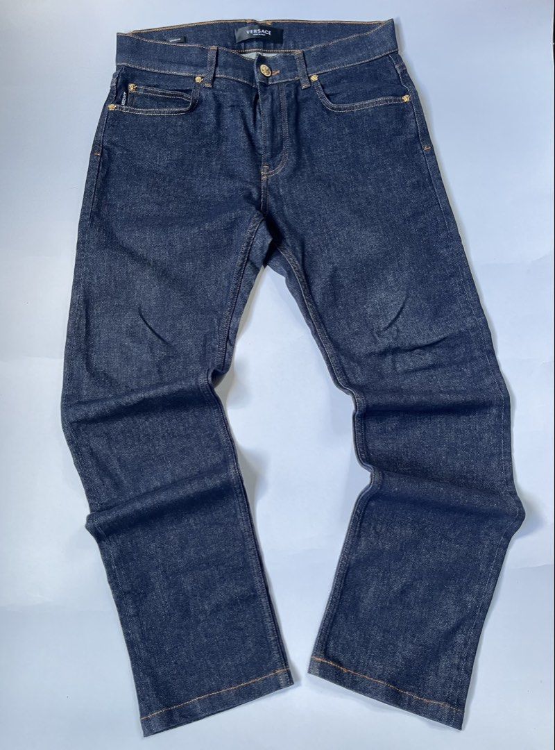 Versace Taylor Fit Dark Denim Jeans (Category: Jeans) located in Dumangas. Submitted by chiiieeef (Listing ID 1466566047, Image 1). Description: - Brand: Versace - Model: Taylor Fit Jeans - Color: Dark Indigo Denim - Material: Made in Italy - Design: Classic five-pocket setup with orange contrast stitching - Hardware: Gold-tone featuring the iconic Medusa head motif on button and rivets - Branding: Black leather rear waistband patch with embossed