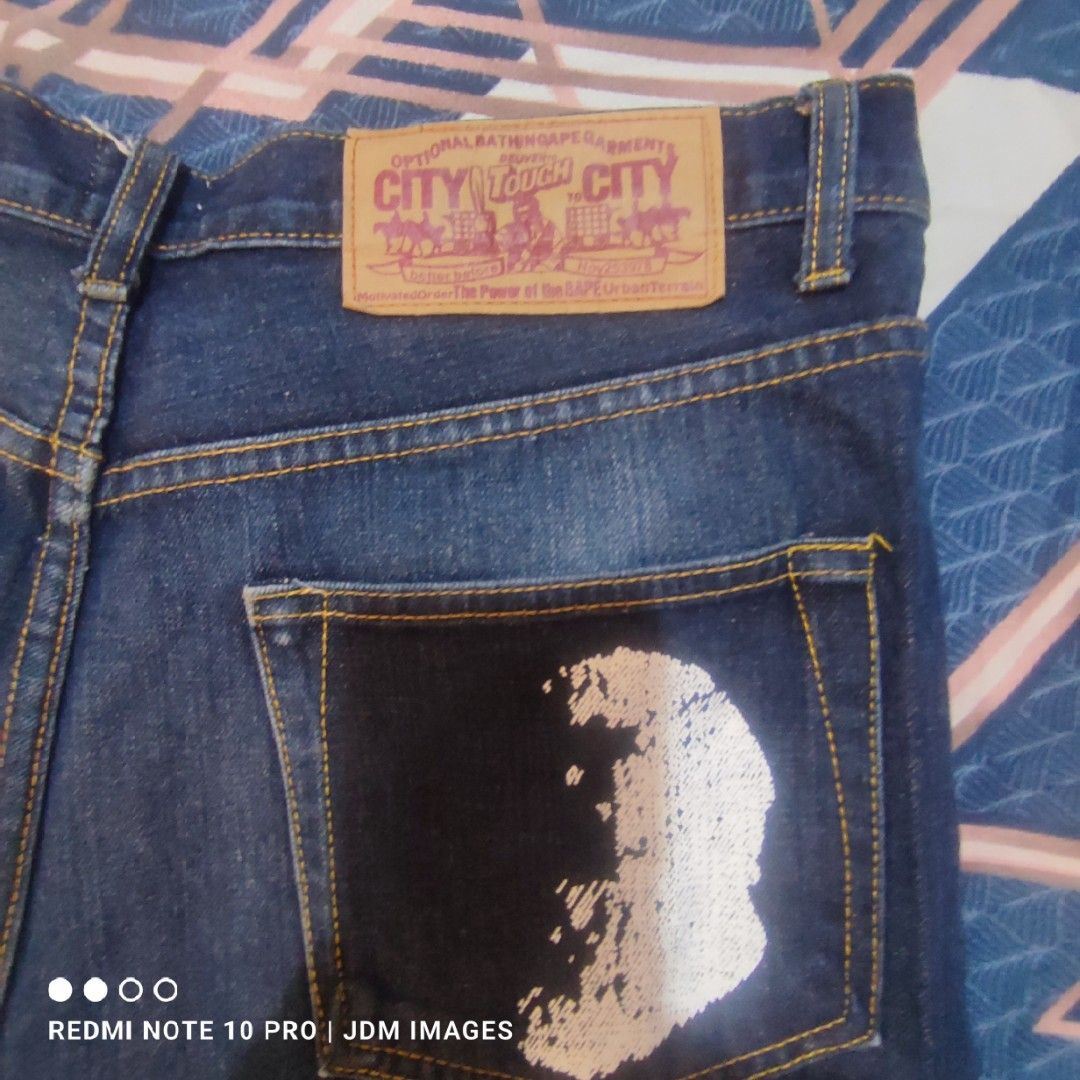 Vintage Bape City Jeans (Category: Jeans) located in Antipolo. Submitted by klashnikov (Listing ID 1466769577, Image 2). Description: - BAPE City Jeans - Classic straight-leg fit - Dark blue wash - Iconic BAPE logo on back pockets - BAPE logo on front pocket - Button closure with BAPE logo Size:XL Dimes: waist 38", Length 42" Tags:complete tags Condition: excellent condition Honest issue: ape logo faded on right pocket see pics Payment option:Ban
