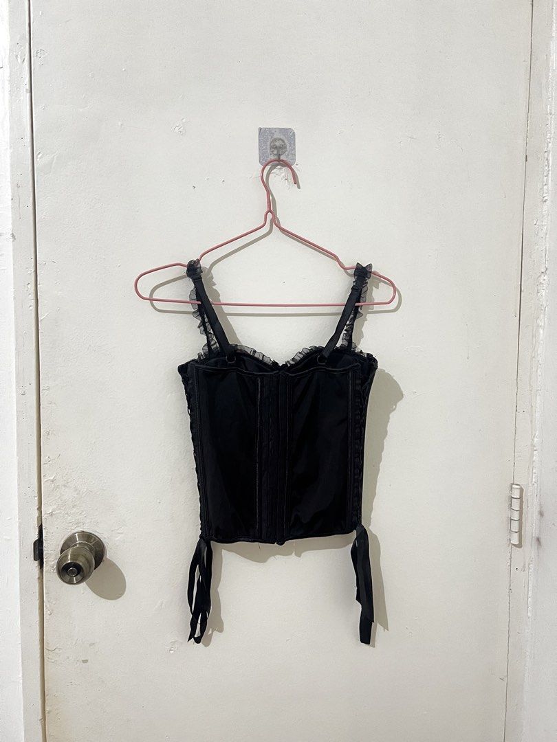 Vintage Black and Red Corset Top (Category: Sleeveless) located in Quezon City. Submitted by http.ashi (Listing ID 1466673091, Image 2). Description: - Vibe: Gothic / vampy style, perfect for nights out - Details: Ruffle trim on neckline and straps, ribbon accents at the hem, and metal hardware - Closure: Front hook-and-eye closure with an adjustable lace-up back - Fit: Adjustable sizing due to the back laces - Size XS- Small .