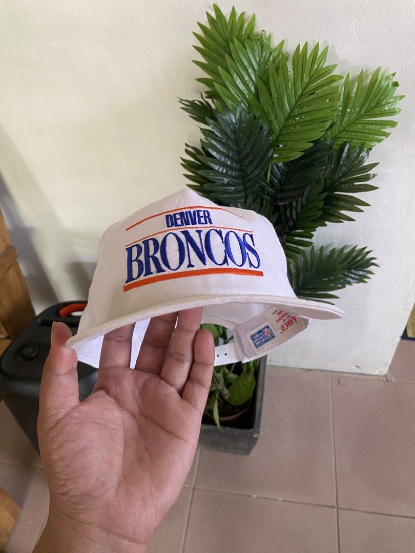 Vintage Denver Broncos Anco Snapback Hat (Category: Caps & Hats) located in Dapitan. Submitted by jadecagatan_4255a7 (Listing ID 1466711028, Image 1). Description: - Brand: Anco - Team: Denver Broncos - Color: White with blue and orange embroidery - Material: 65% polyester, 35% cotton - Closure: Adjustable white plastic snapback - Origin: Officially licensed NFL product made in Taiwan - Size: One size fits all.