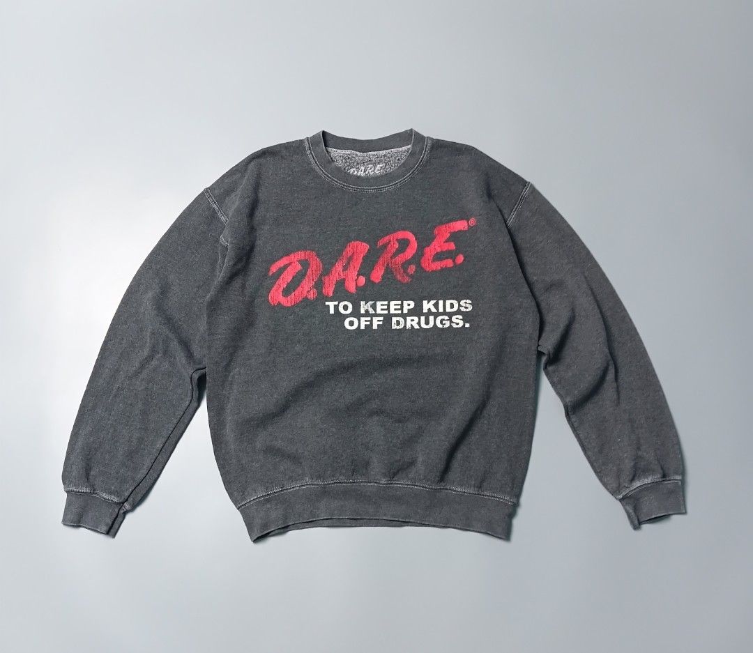 vintage-inspired D.A.R.E. pullover crewneck sweatshirt (Category: Coats, Jackets and Outerwear) located in Manila. Submitted by hustler_777 (Listing ID 1466667870, Image 1). Description: This specific type of screen-printed inner tag is characteristic of modern licensed apparel reproductions rather than authentic vintage items from the 1980s or 1990s (which typically utilized physical, stitched-in brand labels from manufacturers like Hanes, Fruit