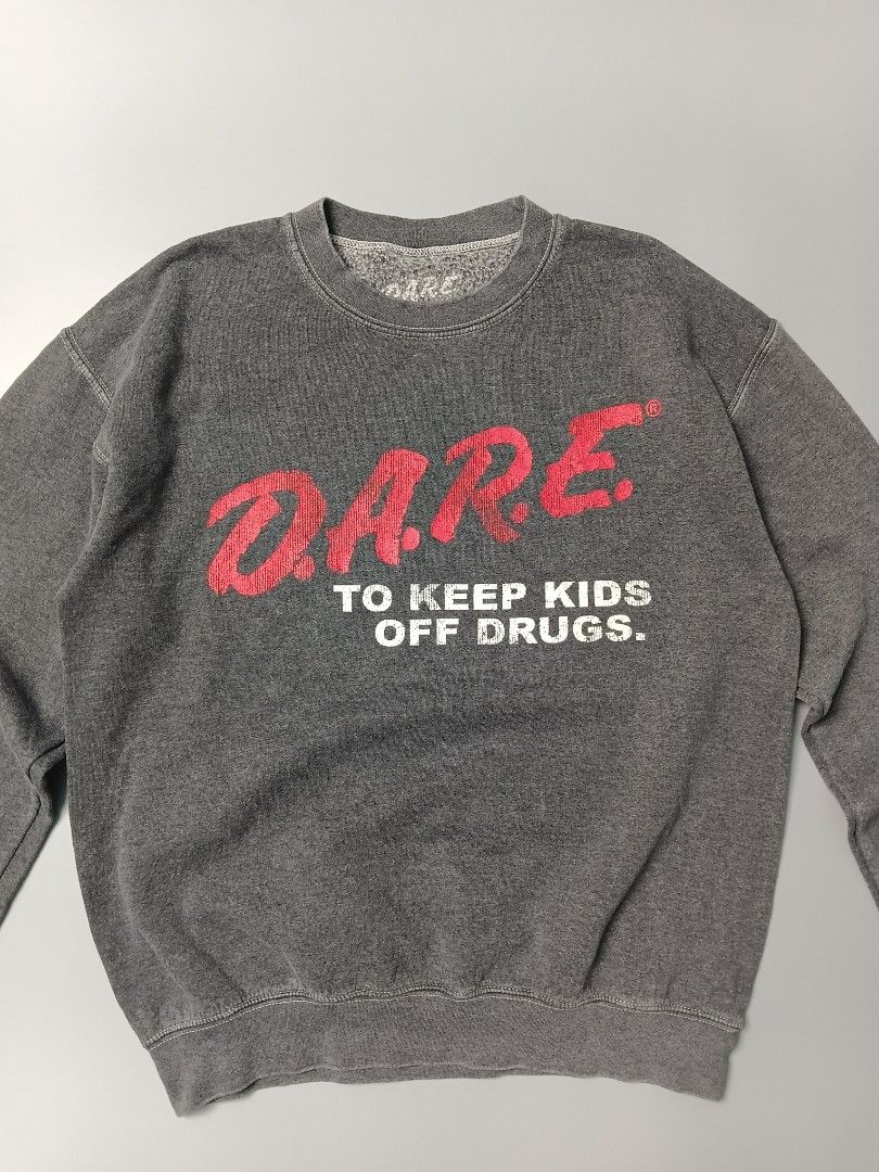 vintage-inspired D.A.R.E. pullover crewneck sweatshirt (Category: Coats, Jackets and Outerwear) located in Manila. Submitted by hustler_777 (Listing ID 1466667870, Image 2). Description: This specific type of screen-printed inner tag is characteristic of modern licensed apparel reproductions rather than authentic vintage items from the 1980s or 1990s (which typically utilized physical, stitched-in brand labels from manufacturers like Hanes, Fruit