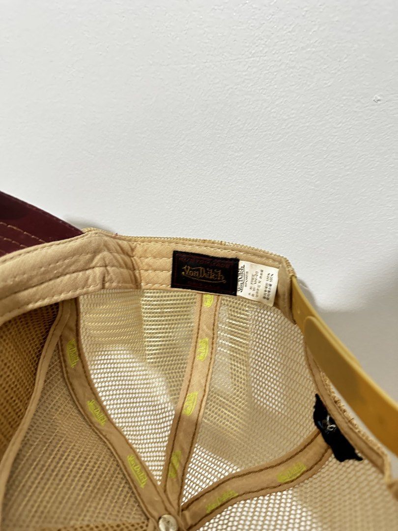 Von Dutch Trucker Hat Maroon and Tan (Category: Caps & Hats) located in Manila. Submitted by driftthrift (Listing ID 1466760221, Image 3). Description: - Brand: Von Dutch - Color: Maroon front with tan mesh back - Design: Gold embroidered logo patch and leather-look brim - Closure: Adjustable snapback - Condition: Clean overall, with clear inside tags for authenticity.