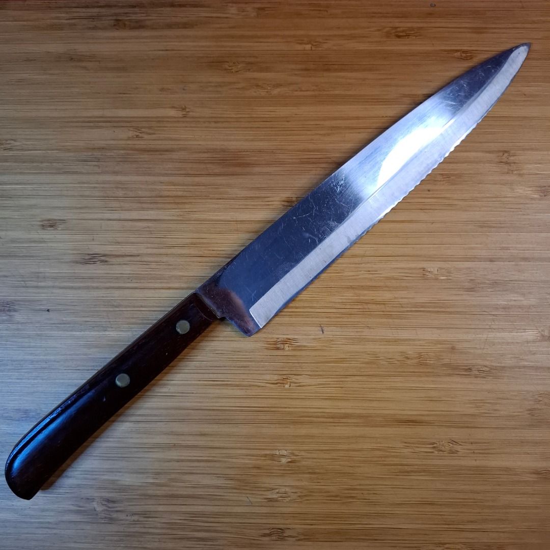 Wayne Micro Edge Stainless Steel Utility Bread Knife (Category: Knives & Chopping Boards) located in Mandaluyong City. Submitted by edward123_andren (Listing ID 1466762634, Image 2). Description: - Brand/Model: Wayne Micro Edge knife - Blade: Serrated stainless steel, perfect for bread, tomatoes, and daily kitchen prep - Handle: Wooden handle secured with durable dual brass rivets - Condition: Solid and reliable with minor surface scratches from 