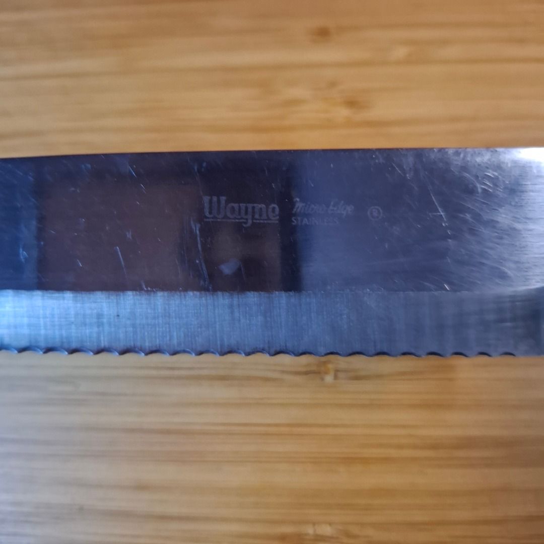 Wayne Micro Edge Stainless Steel Utility Bread Knife (Category: Knives & Chopping Boards) located in Mandaluyong City. Submitted by edward123_andren (Listing ID 1466762634, Image 3). Description: - Brand/Model: Wayne Micro Edge knife - Blade: Serrated stainless steel, perfect for bread, tomatoes, and daily kitchen prep - Handle: Wooden handle secured with durable dual brass rivets - Condition: Solid and reliable with minor surface scratches from 