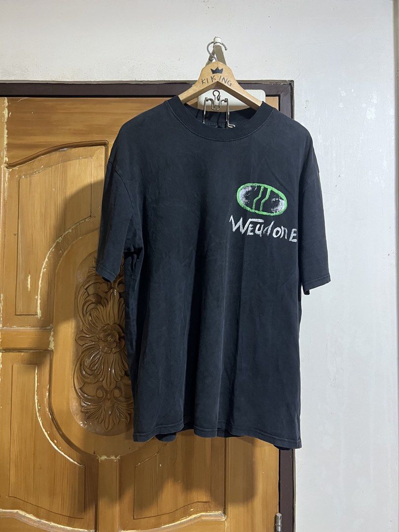 We11done Black Graphic Bear T-Shirt (Category: Tshirts & Polo Shirts ) located in Valencia. Submitted by thrifttomaniac_1225 (Listing ID 1466693178, Image 1). Description: - Color: Black - Fit: Relaxed oversized fit with crew neck - Details: Green & white chest pocket branding, large distressed teddy bear back graphic, and bottom hem woven label - Fabric: Soft washed look, great for streetwear - Condition: Brand new / Excellent quality.