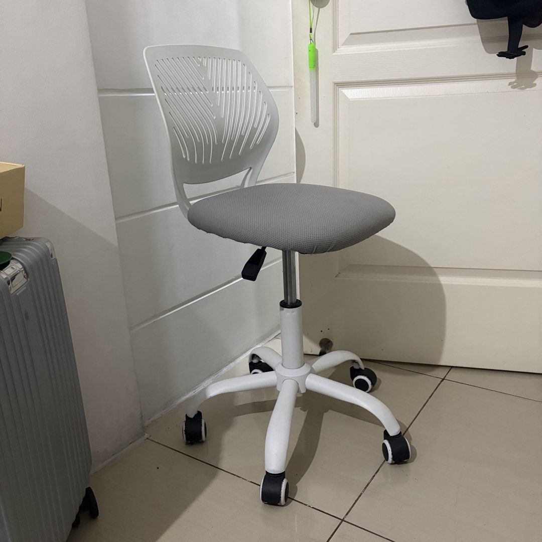 White and Grey Rolling Office Chair (Category: Office Furniture & Fixtures) located in Lucena. Submitted by chelseaabelar (Listing ID 1466693702, Image 2). Description: - Ergonomic rolling office chair with a modern white plastic frame - Breathable grey mesh seat and slatted backrest for all-day comfort - Height-adjustable lever located underneath for easy customization - Sturdy five-star white base with smooth-rolling caster wheels - Compact siz