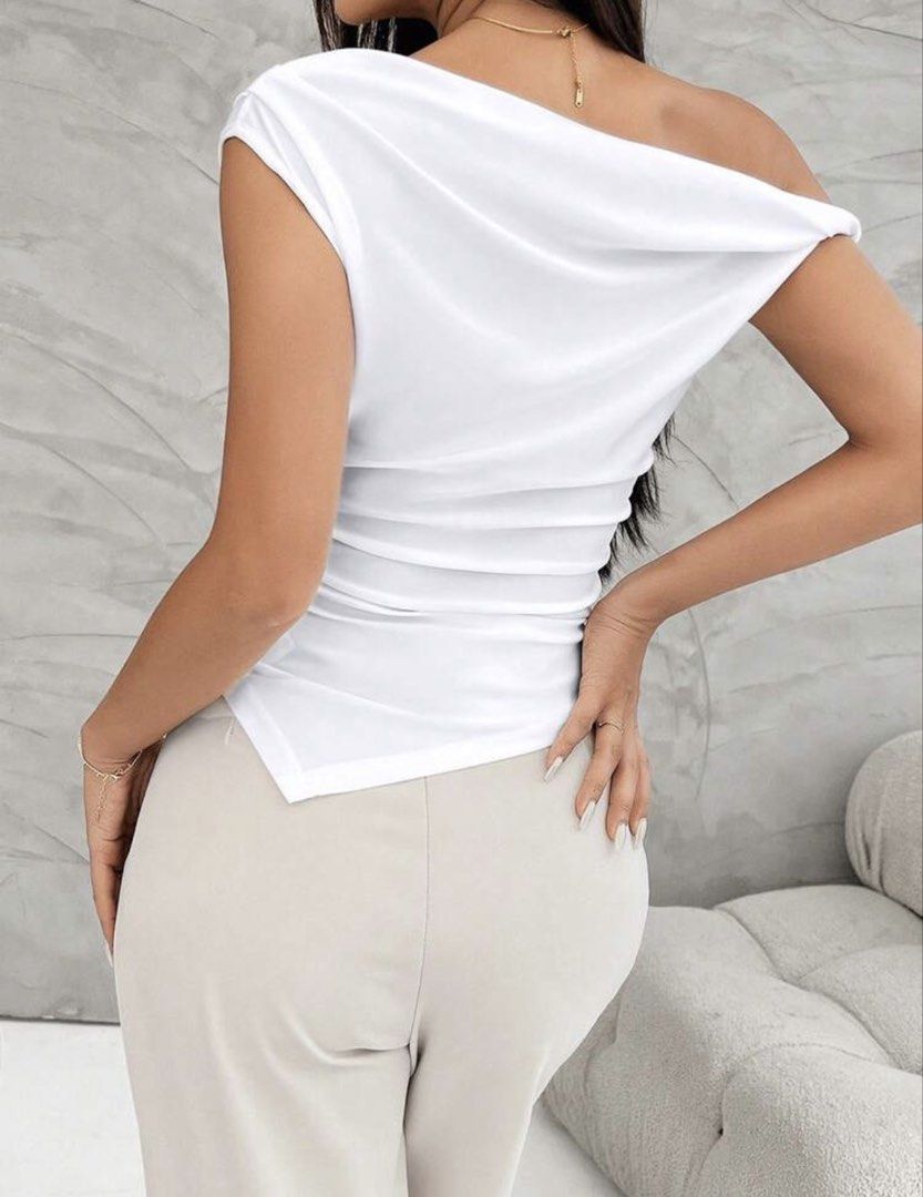 White Asymmetric Drape Shoulder Top (Category: Sleeveless) located in Manila. Submitted by izzmya (Listing ID 1466587972, Image 2). Description: - Color: White - Style: One-shoulder sleeveless top with right-side strap - Design: Asymmetric draped neckline and gathered side details - Fit: Fitted silhouette with a clean back cut - Material: Soft and comfortable fabric - Versatility: Perfect for pairing with casual pants or skirts.