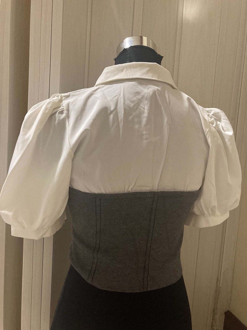 White Blouse Korean Style (Category: Blouses) located in Quezon City. Submitted by shanepenguin (Listing ID 1466672361, Image 2). Description: - 2-in-1 layered design featuring a white button-down blouse and a dark grey knit corset overlay with puff sleeves - Used once .