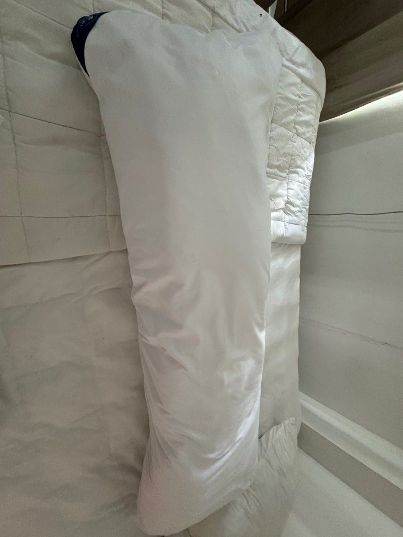 White bolster pillow (Category: Bedding & Towels) located in Manila. Submitted by decluterthings888 (Listing ID 1466589120, Image 1). Description: - Color: Solid white - Shape: Standard cylindrical - Feel: Soft and plush filling - Condition: Clean and well-maintained - Perfect for: Hugging while sleeping or bedroom styling.