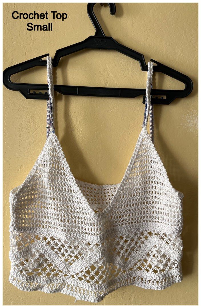 White Crochet Top Small (Category: Blouses) located in Cebu City. Submitted by purgemycloset (Listing ID 1466636961, Image 1). Description: - Size: Small - Color: White with blue and white braid detail - Material: Lightweight, breathable handmade crochet knit - Design: V-neckline, adjustable spaghetti straps, open-weave chevron pattern - Condition: Brand new / Excellent - Perfect for: Warm weather, beach cover-ups, and layering.