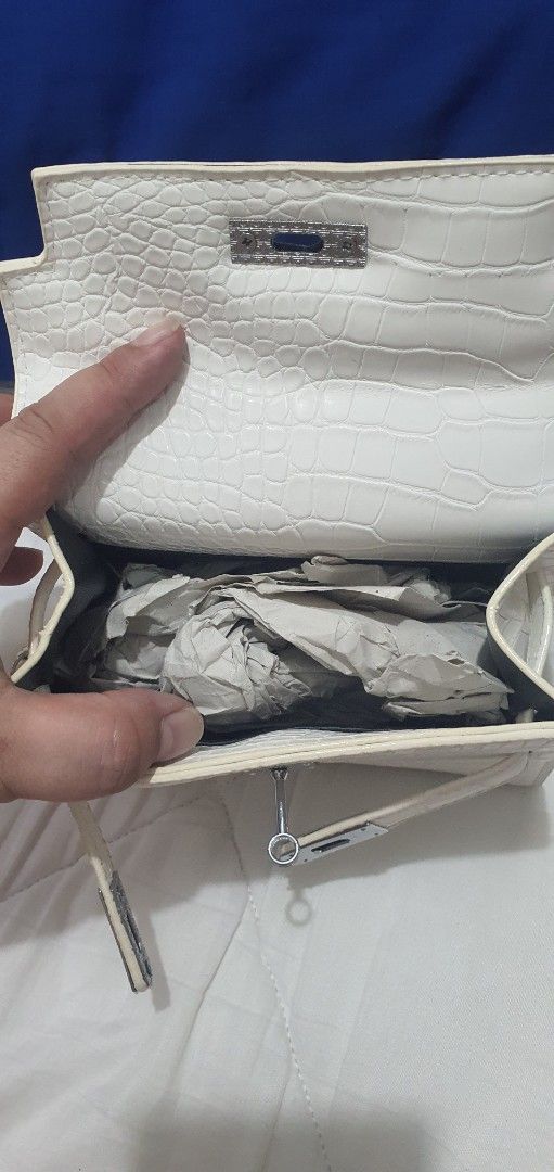 White Crocodile Pattern Mini Handbag with Strap (Category: Cross-body Bags) located in Paranaque City. Submitted by personal_preloved40 (Listing ID 1466654480, Image 3). Description: - Color: White with stylish crocodile texture - Material: Premium faux leather with silver-tone hardware - Versatile carry: Includes single top handle and adjustable/removable shoulder strap - Interior: Clean black fabric lining with shape-preserving paper stuffing -