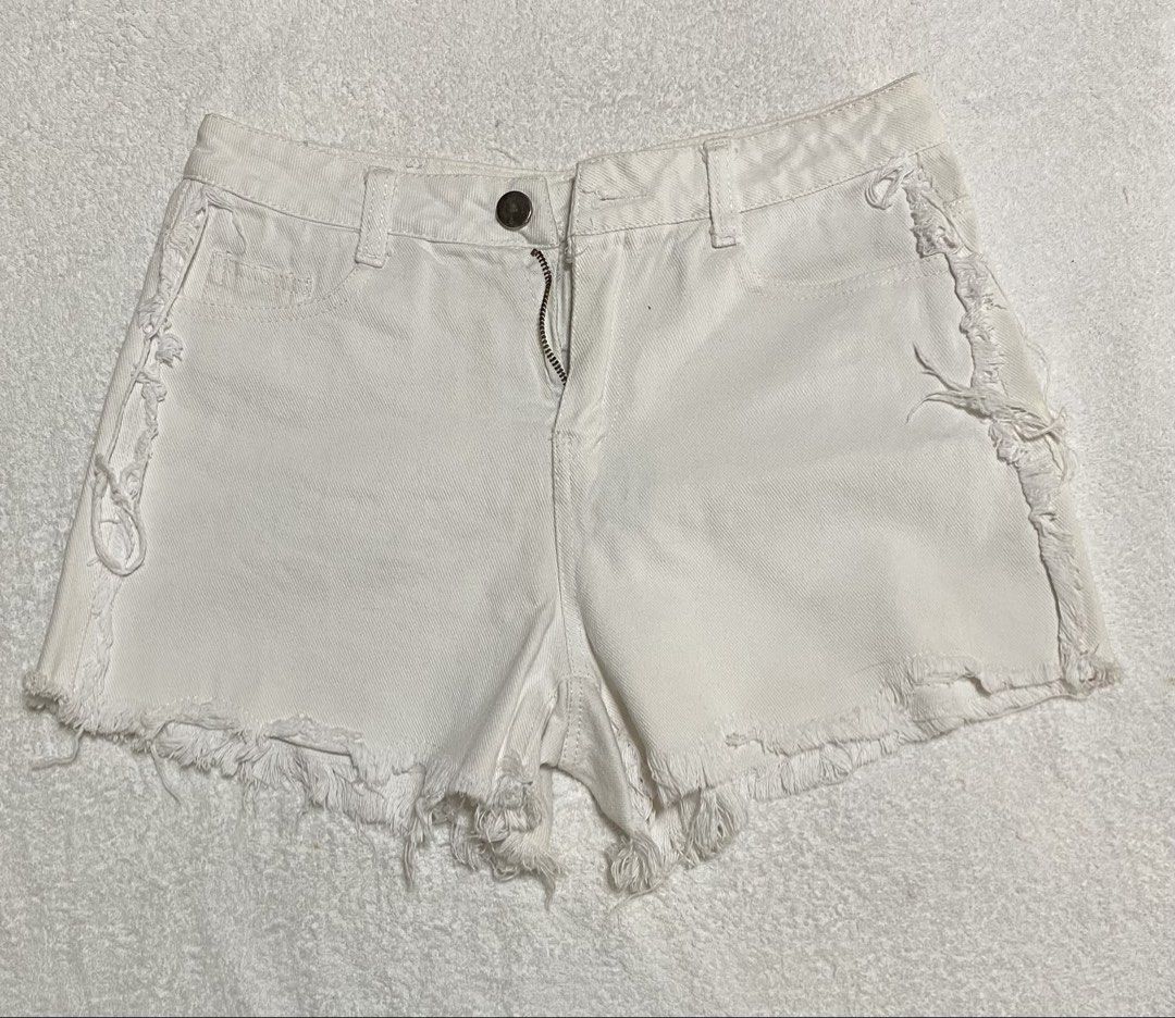 White Distressed Raw Hem Denim Shorts (Category: Babies & Kids Fashion) located in Morong. Submitted by fcjonline528 (Listing ID 1466656082, Image 1). Description: - Color: White - Style: Mid-rise denim shorts with heavy distressing - Details: Frayed raw hems and trendy fringe side seams - Closure: Classic button and zipper fly - Condition: Great basic piece, easy to style with tees and crop tops.