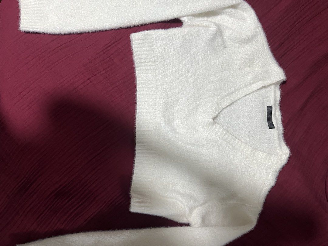 White fuzzy crop sweater with V-neck (Category: Coats, Jackets and Outerwear) located in Manila. Submitted by new.gabrielle (Listing ID 1466648418, Image 1). Description: - Color: White - Style: Cropped sweater with classic V-neck - Details: Long sleeves with ribbed cuffs and hem, soft textured knit material - Fit: Super cozy and easy to match with high-waisted jeans or skirts.